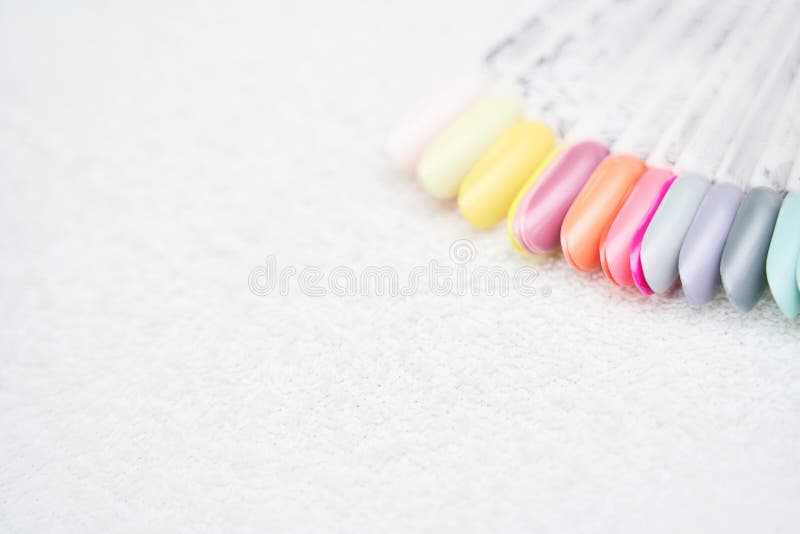 Defferent nail gel wheel sample on white background. Beautiful salon procedure with pink pedicure or manicure. For decoration design. Healthcare. Woman body care. Spa treatment. Nail brush
