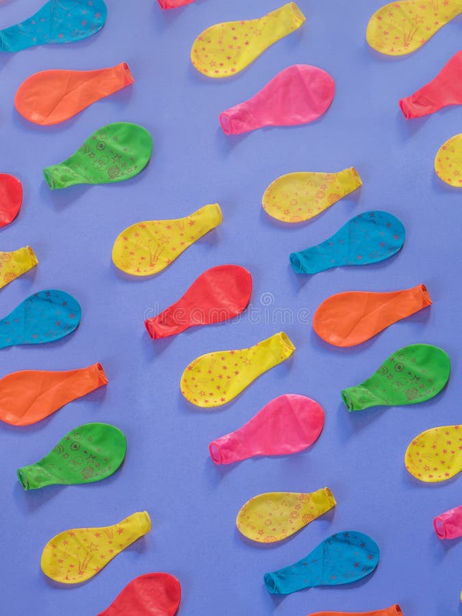 Deflated balloons pattern on purple stock photos Deflated balloons pattern on purple stock photos