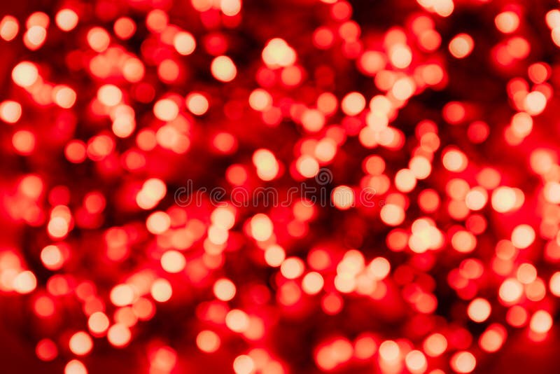Defocused image of illuminated red circles of lights on a dark background stock photo