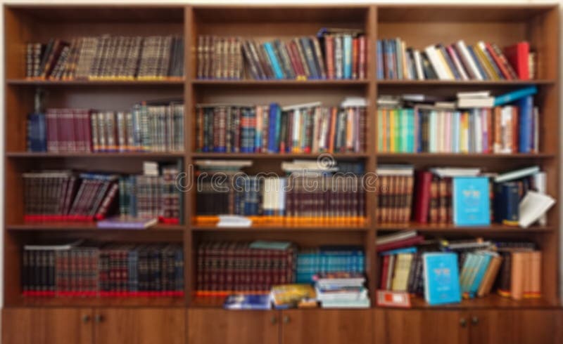 Defocused image. Multi-colored books on the bookshelf in the library. The bokeh effect royalty free stock photo