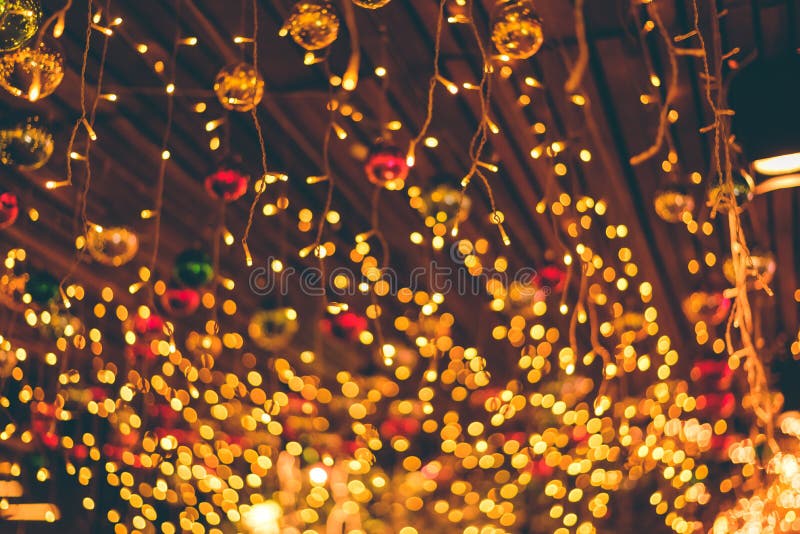Defocused Ligths Of Christmas Ornaments Hanging From Ceiling