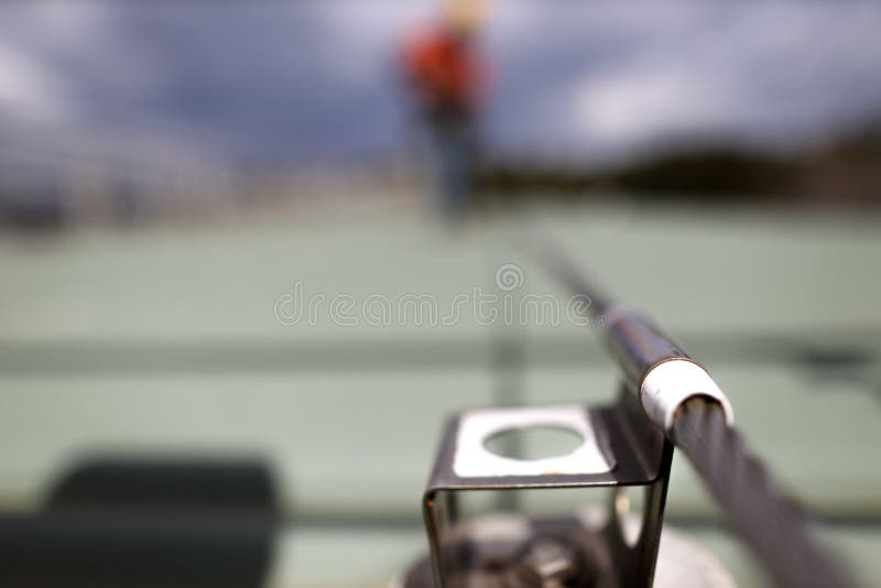 Defocused of rope access inspector technician inspecting fall arrest, fall restraint roof anchor point stock photography Defocused of rope access inspector technician inspecting fall arrest, fall restraint roof anchor point stock photography