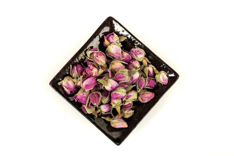 Dehydrated Pink Rose Buds in a Ceramic Plate Top Down View Stock Photo