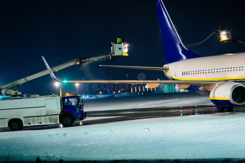 Deicing passenger airplane during heavy snow