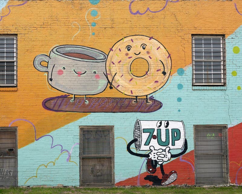 Pictured is a part of a colorful two story mural painted to advertise Tom Thumb Express and 7-Up in Dallas, Texas.  The talented mural artist is Lesli Marshal working with exploredinary, a creative agency that blends the talents and aesthetics of artists Sarah Reyes and Daniel Driensky.  The mural includes a grocer, cup of coffee, donut, popcorn, hot dog, milk and cookie. Pictured is a part of a colorful two story mural painted to advertise Tom Thumb Express and 7-Up in Dallas, Texas.  The talented mural artist is Lesli Marshal working with exploredinary, a creative agency that blends the talents and aesthetics of artists Sarah Reyes and Daniel Driensky.  The mural includes a grocer, cup of coffee, donut, popcorn, hot dog, milk and cookie.
