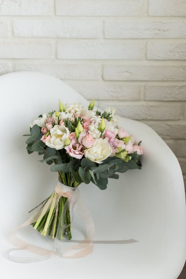 Delicate bridal bouquet on a chair