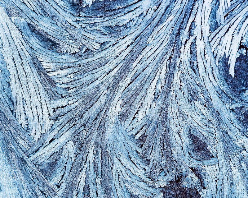 Delicate patterns of frost crystals on a sparkling glass stock images