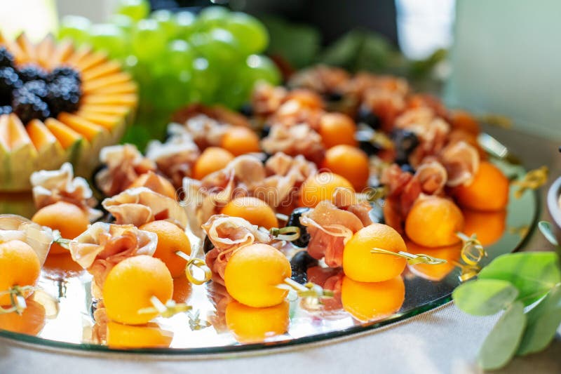 Delicious Appetizers with Prosciutto and Peach at Party. Close Up