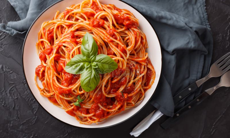 Delicious and appetizing pasta. Black table. stock photo