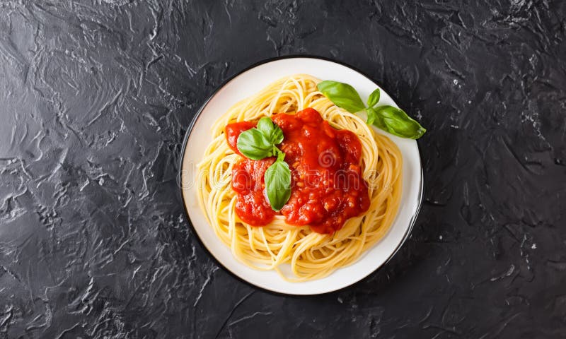 Delicious and appetizing pasta. Black table. stock images