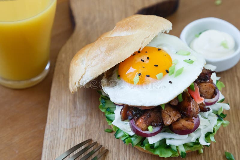 A Delicious Asian Style Hamburger Garnished with Lettuce, Onion and