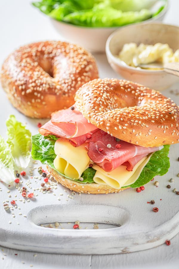 Delicious bagel with cheese and ham for fresh breakfast