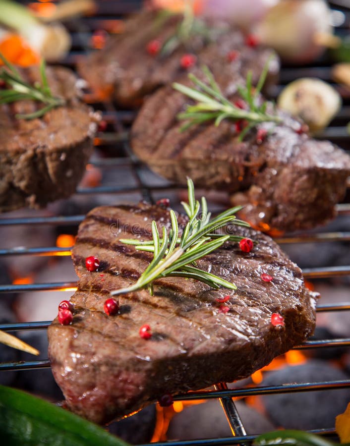 Delicious Beef Steaks with Vegetable on a Barbecue Grill. Stock Image