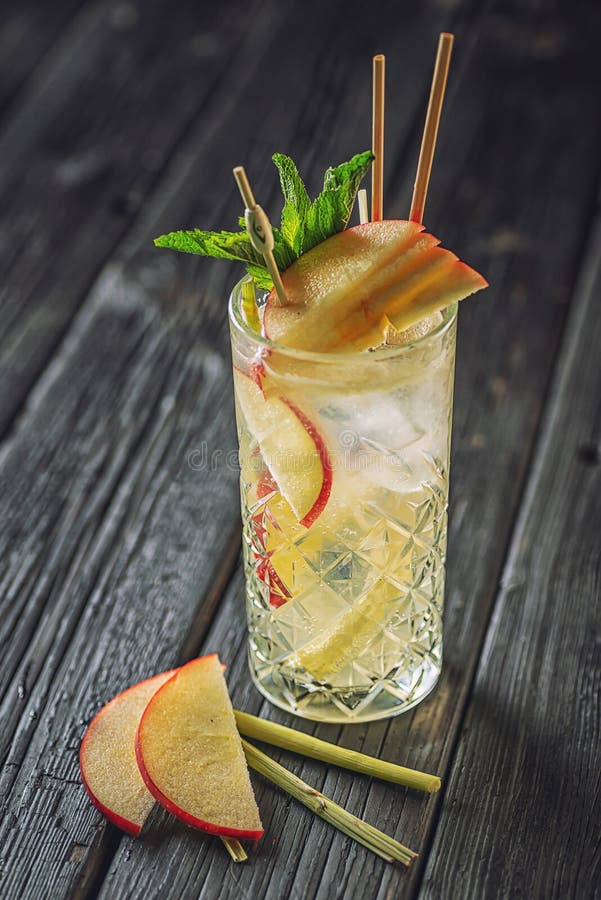 Delicious Cocktail on Table in Bar. Alcoholic Coctail with Fruit, Herbs