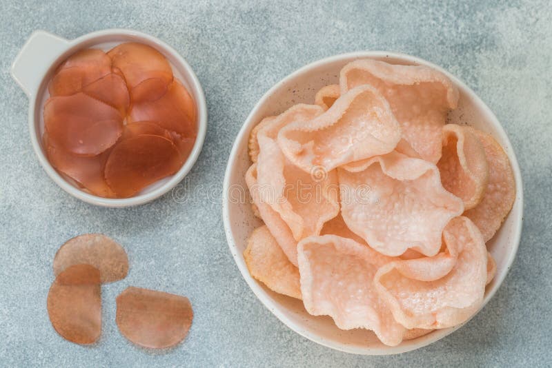 Delicious crispy chips made of starch, flour and shrimp. Bowl of Krupuk prawn crackers. Traditional Asian snack. A dish of Indonesian, Malaysian, Chinese, Korean, Japanese cuisine. Selective focus