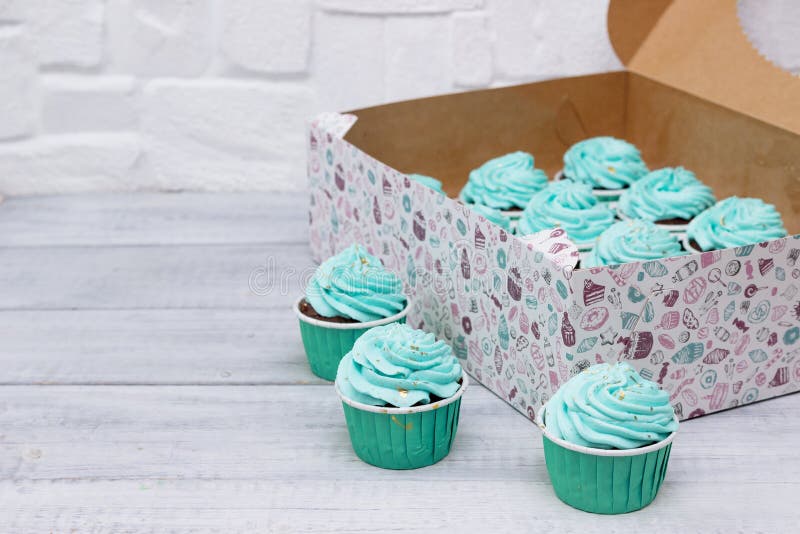 Delicious Cupcakes with Blue Cream in a Box for Cakes Stock Image