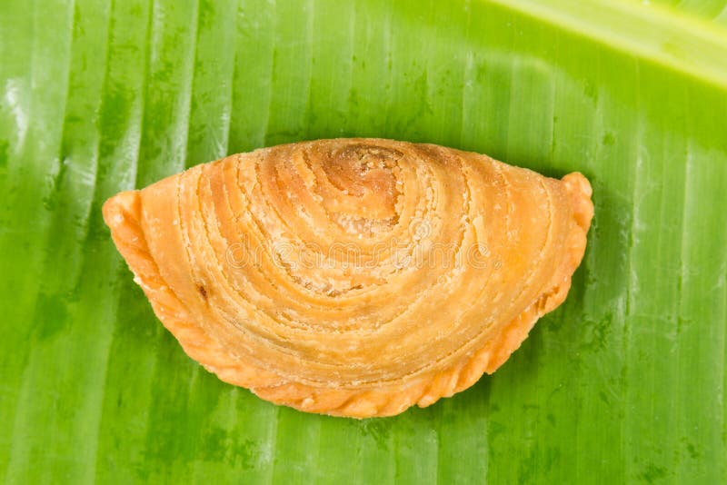 Delicious curry puffs on banana leaf stock image