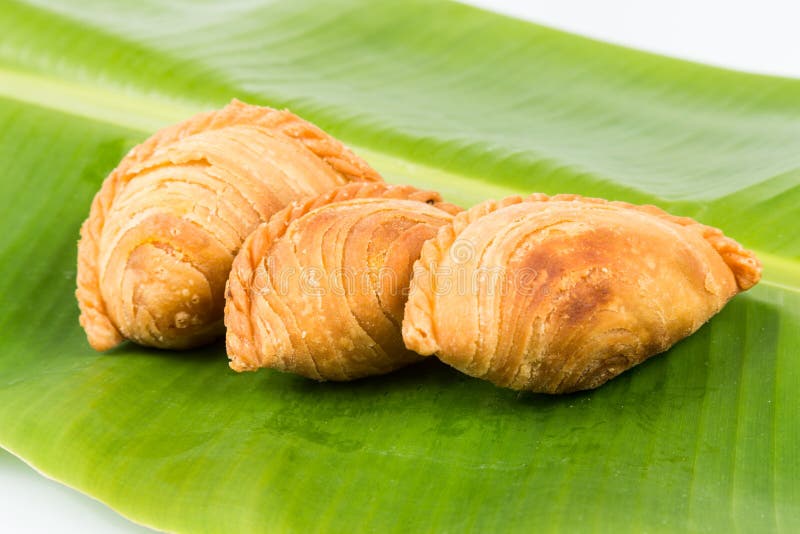 Delicious curry puffs on banana leaf stock images