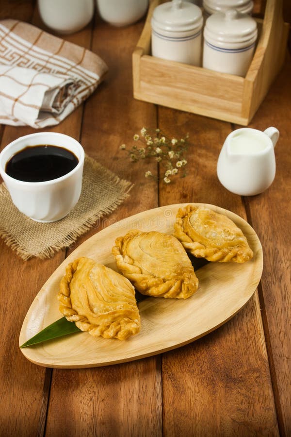 Delicious curry puffs on wooden plate royalty free stock images