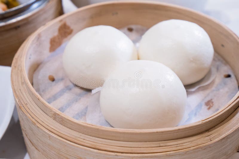 Delicious dim sum, famous cantonese food in asia, fresh and hot salted creamy custard buns in bamboo steamer in hong kong yumcha. Restaurant, close up royalty free stock photography Delicious dim sum, famous cantonese food in asia, fresh and hot salted creamy custard buns in bamboo steamer in hong kong yumcha. Restaurant, close up royalty free stock photography