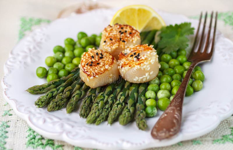 A Delicious Dinner of Roasted Scallops and Asparagus Stock Photo
