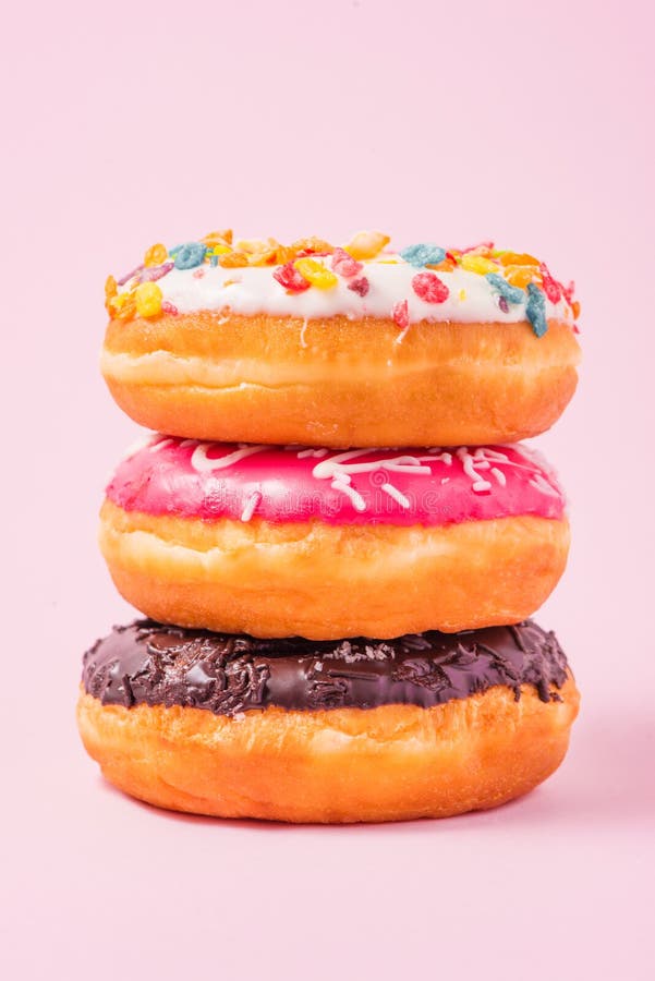 Delicious donuts for birthday on pastel pink background. royalty free stock photography Delicious donuts for birthday on pastel pink background. royalty free stock photography
