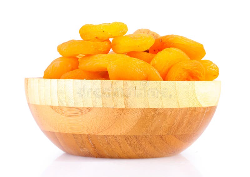 Delicious dried apricots in wooden bowl stock photos
