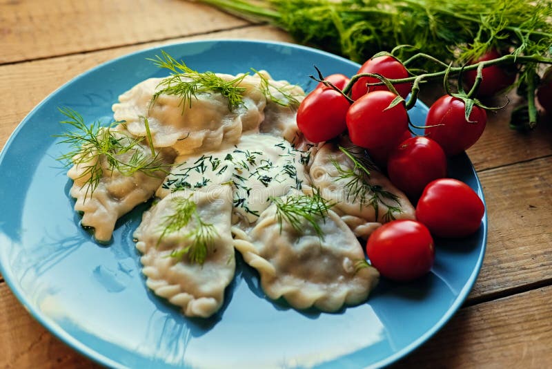 Delicious dumplings with parsley on a blue plate. stock images