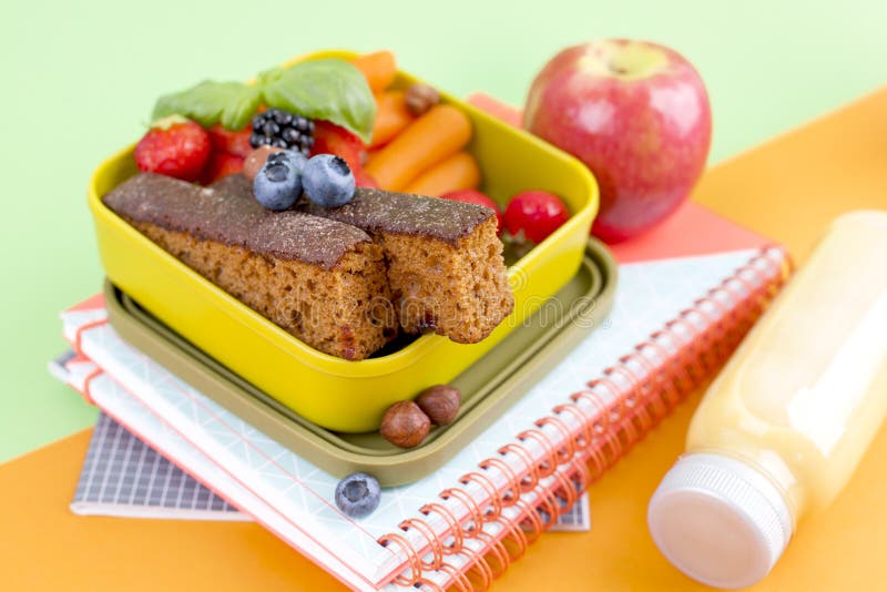 Delicious Dutch breakfast with sweet bread and berries. Food for children in school. School accessories and exercise books. Top royalty free stock photo Delicious Dutch breakfast with sweet bread and berries. Food for children in school. School accessories and exercise books. Top royalty free stock photo