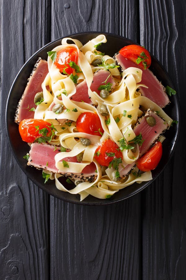 Delicious fettuccine pasta with tuna steak, tomatoes and capers