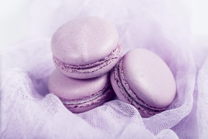Delicious french dessert. Three gentle soft pink cakes macaron or macaroon on airy fabric stock photography Delicious french dessert. Three gentle soft pink cakes macaron or macaroon on airy fabric stock photography