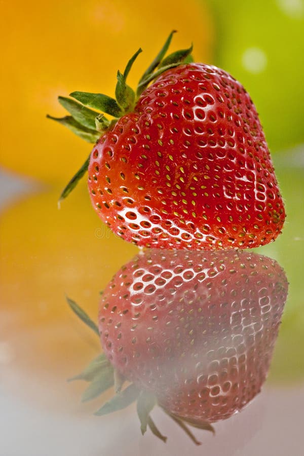 Delicious fresh fruit reflected on glass table
