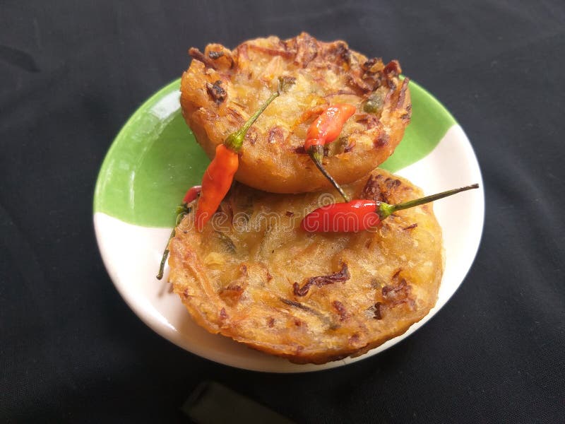 Delicious fried vegetables and spicy chilies on a small plate stock photography