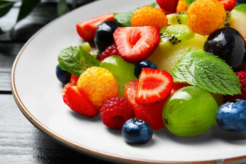 Delicious fruit salad in plastic cup on white background Stock Photo - Alamy