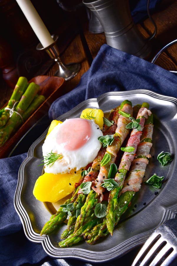 A delicious green asparagus wrapped in bacon and egg. Delicious green asparagus wrapped in bacon and egg royalty free stock images A delicious green asparagus wrapped in bacon and egg. Delicious green asparagus wrapped in bacon and egg royalty free stock images