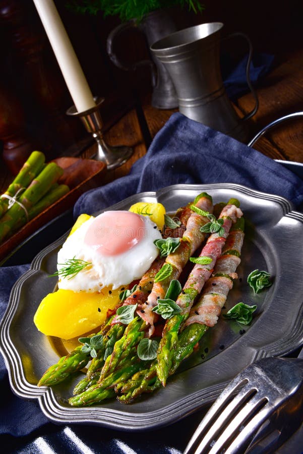 A delicious green asparagus wrapped in bacon and egg. Delicious green asparagus wrapped in bacon and egg stock images A delicious green asparagus wrapped in bacon and egg. Delicious green asparagus wrapped in bacon and egg stock images