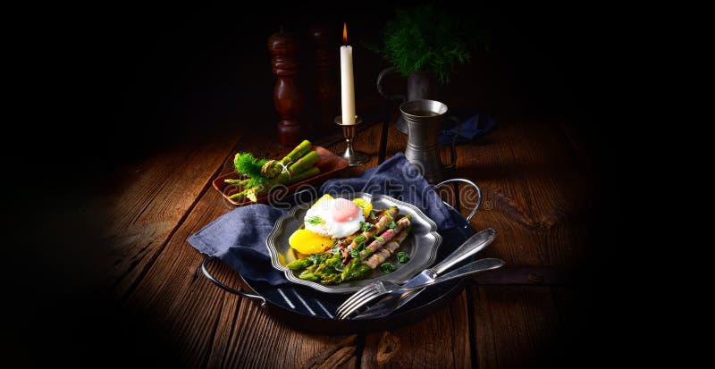 A delicious green asparagus wrapped in bacon and egg. Delicious green asparagus wrapped in bacon and egg stock photography A delicious green asparagus wrapped in bacon and egg. Delicious green asparagus wrapped in bacon and egg stock photography