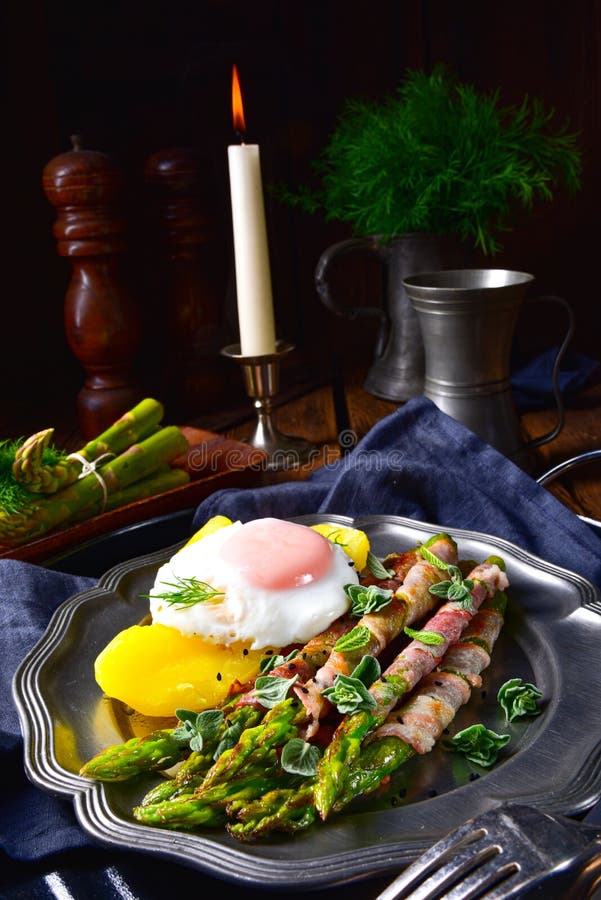 A delicious green asparagus wrapped in bacon and egg. Delicious green asparagus wrapped in bacon and egg royalty free stock photo A delicious green asparagus wrapped in bacon and egg. Delicious green asparagus wrapped in bacon and egg royalty free stock photo