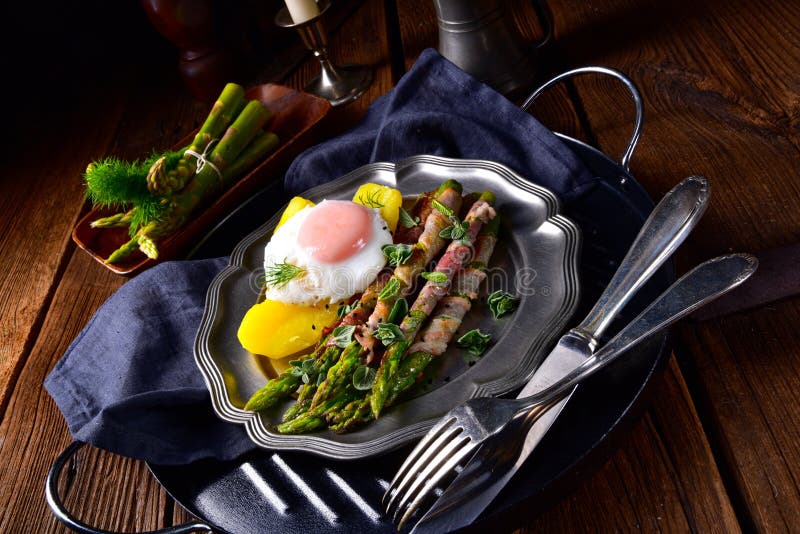 A delicious green asparagus wrapped in bacon and egg. Delicious green asparagus wrapped in bacon and egg stock photography A delicious green asparagus wrapped in bacon and egg. Delicious green asparagus wrapped in bacon and egg stock photography