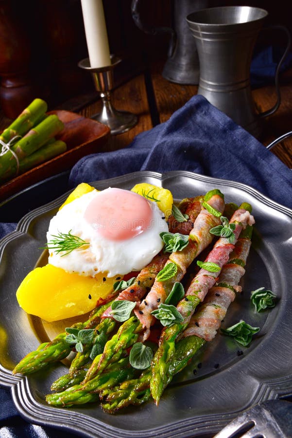 A delicious green asparagus wrapped in bacon and egg. Delicious green asparagus wrapped in bacon and egg royalty free stock images A delicious green asparagus wrapped in bacon and egg. Delicious green asparagus wrapped in bacon and egg royalty free stock images
