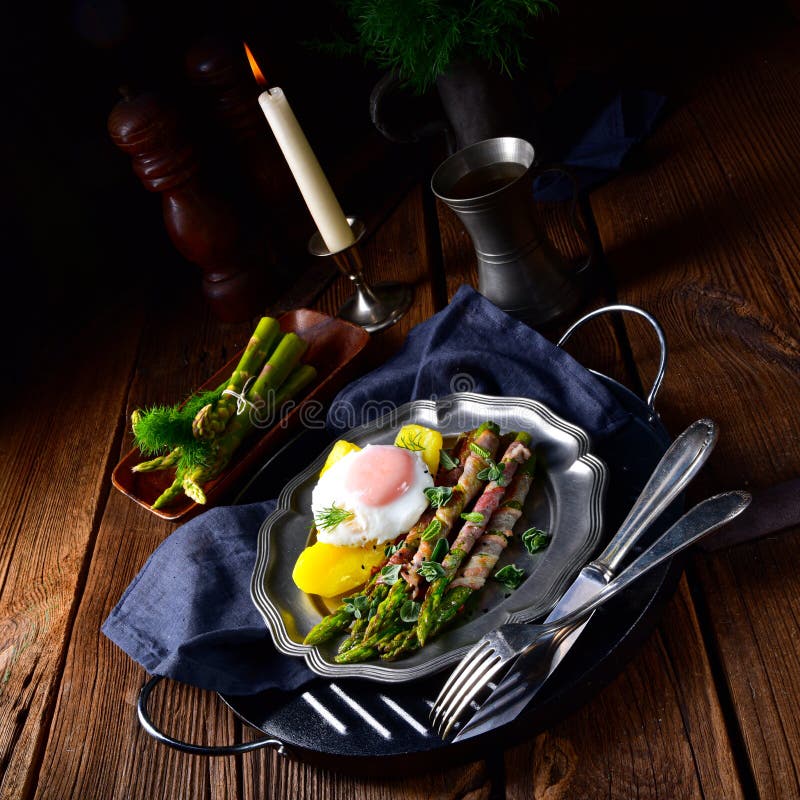 A delicious green asparagus wrapped in bacon and egg. Delicious green asparagus wrapped in bacon and egg stock images A delicious green asparagus wrapped in bacon and egg. Delicious green asparagus wrapped in bacon and egg stock images