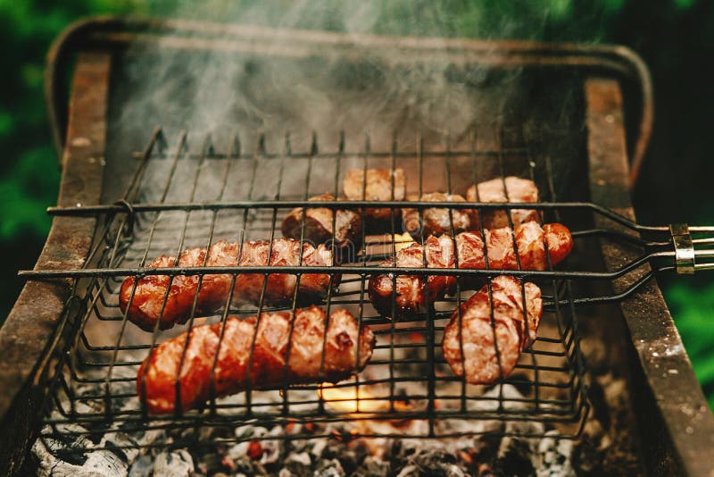 Delicious Grilled Sausages Roasting on Grates with Flames and Sm Stock ...