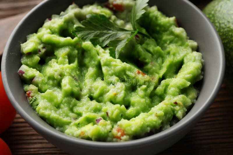 Delicious guacamole with parsley on table, closeup royalty free stock photography