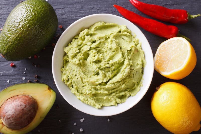 Delicious guacamole sauce close-up on the table. Horizontal top royalty free stock photography