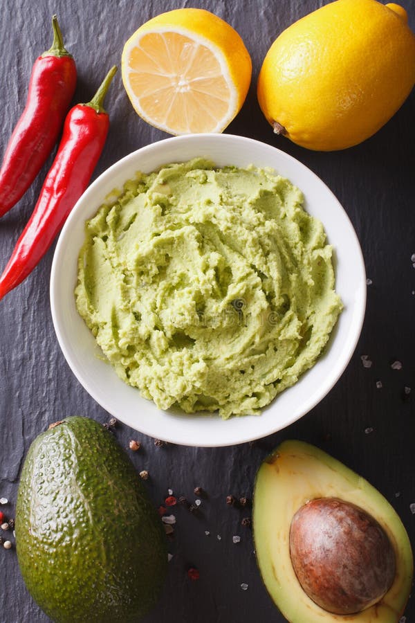 Delicious guacamole sauce close-up on the table. vertical top view stock photos