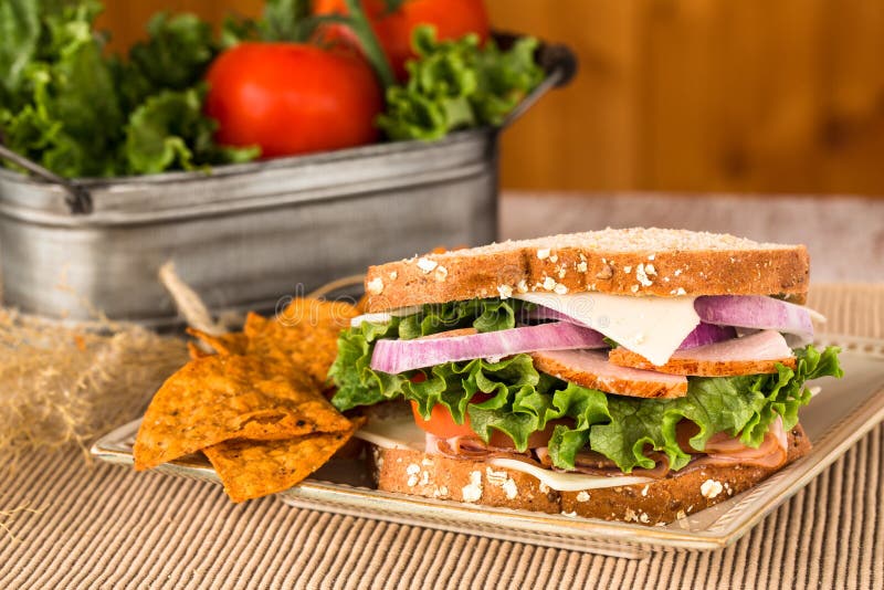 Lunch Sandwich with Ham Turkey Swiss Cheese and Chips Stock Image