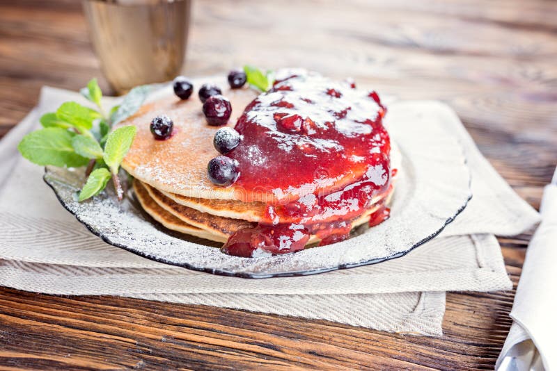 Delicious and healthy breakfast of pancakes with berries, jam