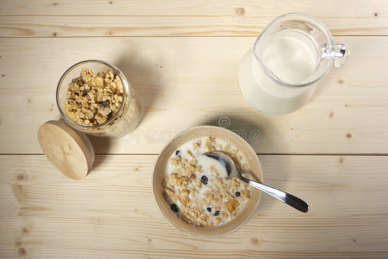 Delicious and healthy cereal in bowl with milk on table stock images