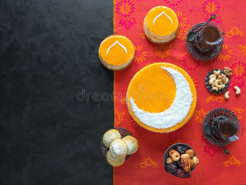 Delicious homemade golden cake with a Crescent moon, served with black coffee and dates. Ramadan background, copy space