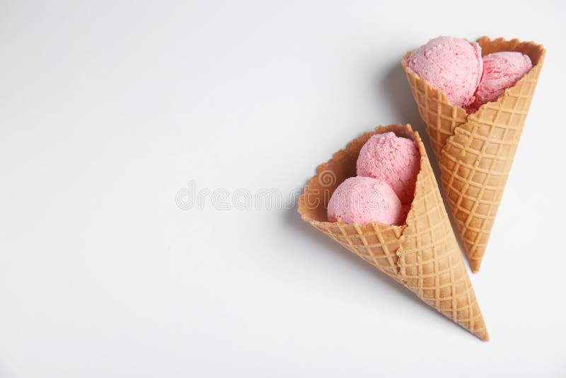 Delicious ice creams in wafer cones on white, top view